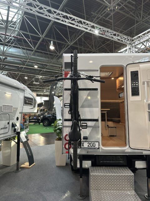 Geöffnete Tischer BOX 200 Kabine mit hochgeklapptem Fahrradträger am Heck.